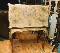 The French polish of this elegant 19th century card table was perished and the wood bleached by strong sunlight.